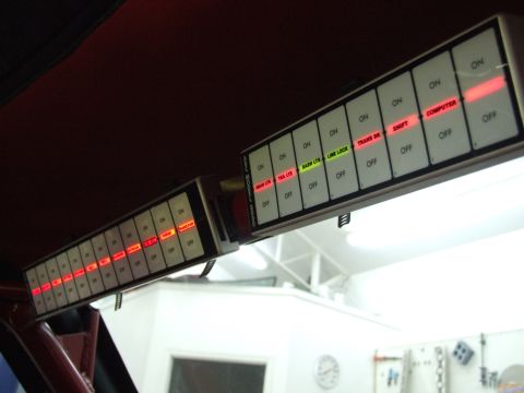 1990 Ford Mustang - Custom switch panel with multiple illuminated buttons for various vehicle functions.