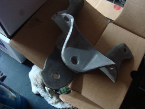 1992 Ford Bronco - Metal brackets are shown resting on cardboard packaging.