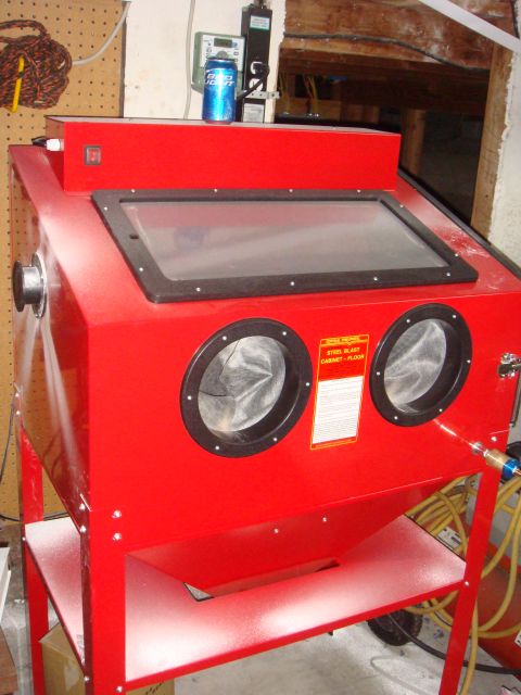 1992 Ford Bronco - This red sandblaster cabinet has a clear viewing window and two glove ports for operation.