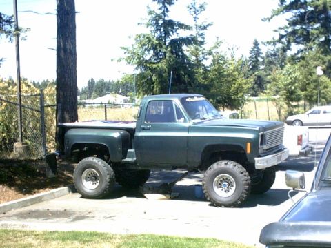 1976 Chevrolet C/K Pickup - This lifted 1976 Chevrolet C/K Pickup is shown from a 3q-front angle, highlighting its modified suspension and off-road tires.