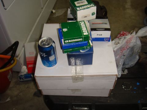1992 Ford Bronco - Boxes of bearings and a can of soda are piled on top of larger boxes.