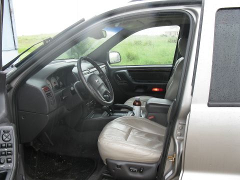 2001 Jeep Grand Cherokee - The interior of a 2001 Jeep Grand Cherokee is visible, leather seats and the dashboard.