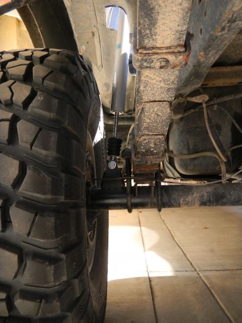 1997 Ford Ranger - This image shows the rear axle and suspension of a vehicle, with a focus on the tire and leaf springs.