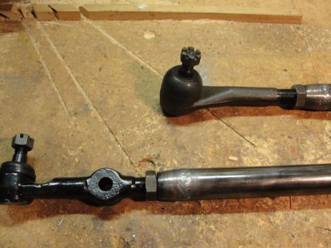 1995 Ford Bronco - Close-up of two tie rod ends, likely for a vehicle's steering system.