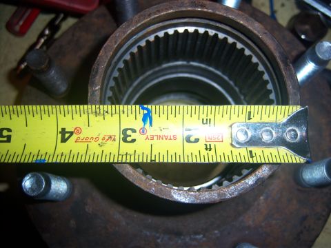 1996 Ford Bronco - A close-up view of a vehicle hub being measured with a yellow tape measure.
