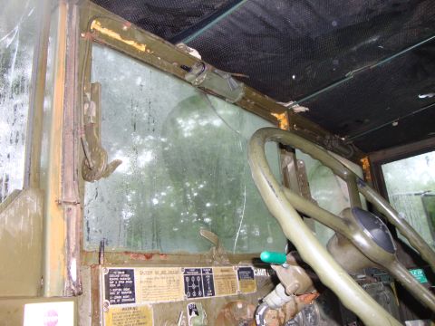 1970 Jeep Commando - Interior view of a vintage truck, focusing on the dashboard and steering wheel, with visible warning labels.