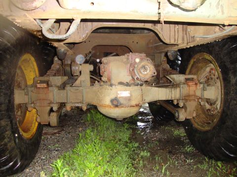 1970 Jeep Commando - The underside of a vehicle reveals its heavy-duty suspension and drivetrain components.