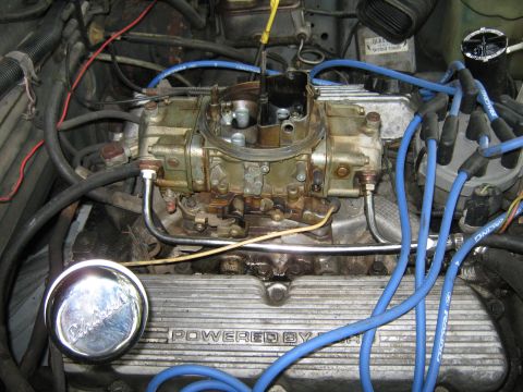 1985 Ford Mustang - Close-up of an engine bay, focusing on the carburetor and valve cover.