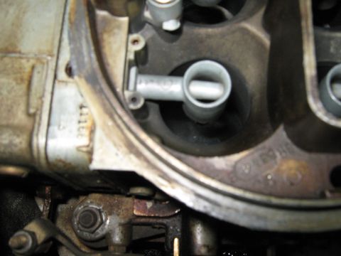 1985 Ford Mustang - A close-up view of the internal components of a carburetor, showing a fuel delivery tube.