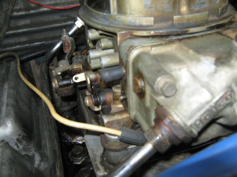 1985 Ford Mustang - A detailed view of a vehicle's carburetor, showing its mechanical components and wiring.