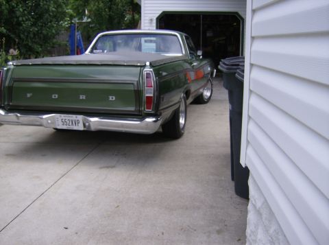 1970 Ford Ranchero - Green 1970 Ford Ranchero parked in a driveway next to a garage.