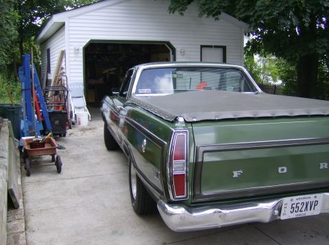 1970 Ford Ranchero - The rear view of a green 1970 Ford Ranchero shows its tailgate and chrome bumper.