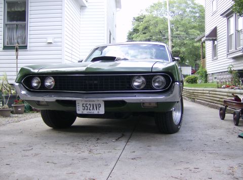 1970 Ford Ranchero - This 1970 Ford Ranchero is presented from a low front angle, highlighting its grille and hood scoop.