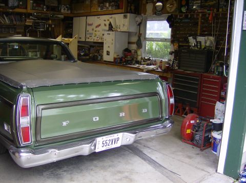 1970 Ford Ranchero - Rear view of a green 1970 Ford Ranchero pickup truck parked in a garage.