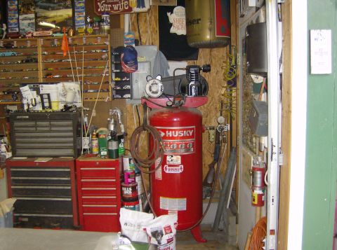 1970 Ford Ranchero - Garage scene filled with tools, storage, and a large air compressor.