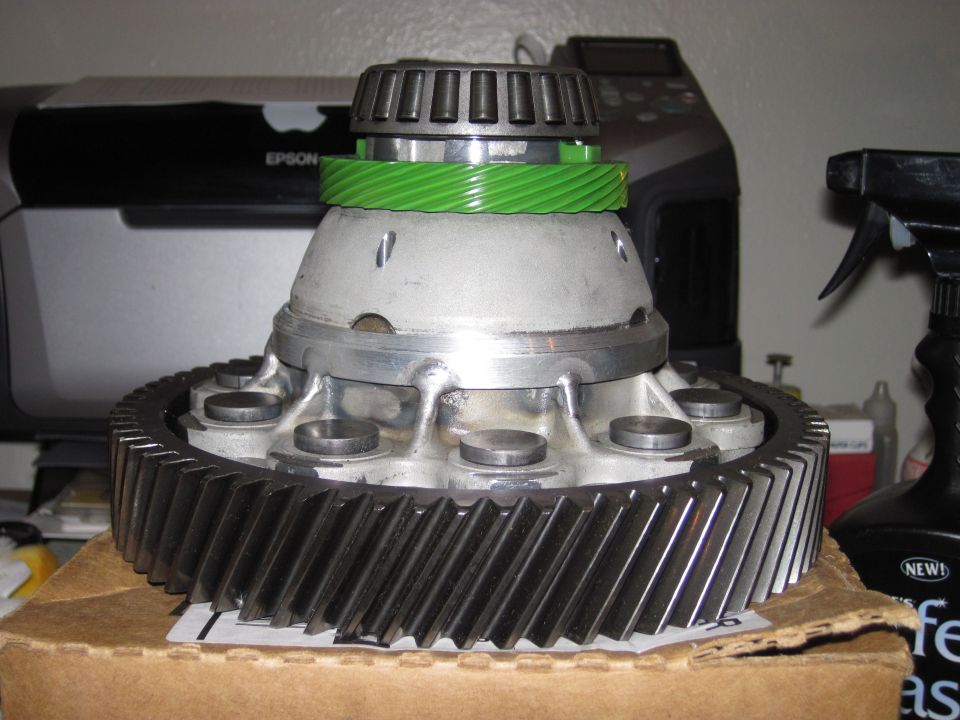 Transaxle differential with helical ring gear, green drive gear and roller bearing on a box