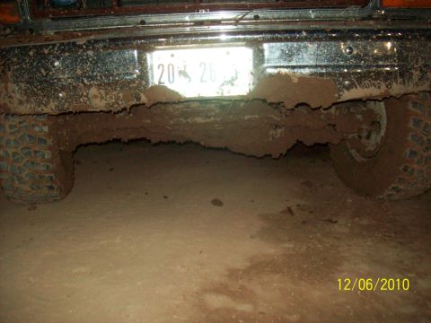 1985 Ford Bronco - This vehicle appears to have recently driven through significant mud, obscuring details of its make and model.