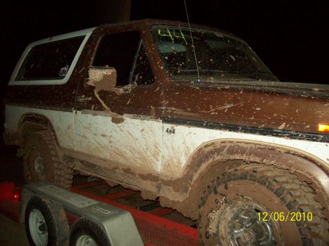 1985 Ford Bronco - This 1985 Ford Bronco is heavily covered in mud, suggesting recent off-road use, and is shown here on a trailer.