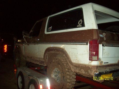 1985 Ford Bronco - This 1985 Ford Bronco is covered in mud and loaded onto a trailer at night.