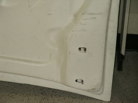 1990 Ford Bronco - The underside of a white hood reveals mounting points and a Supermotors.net watermark.
