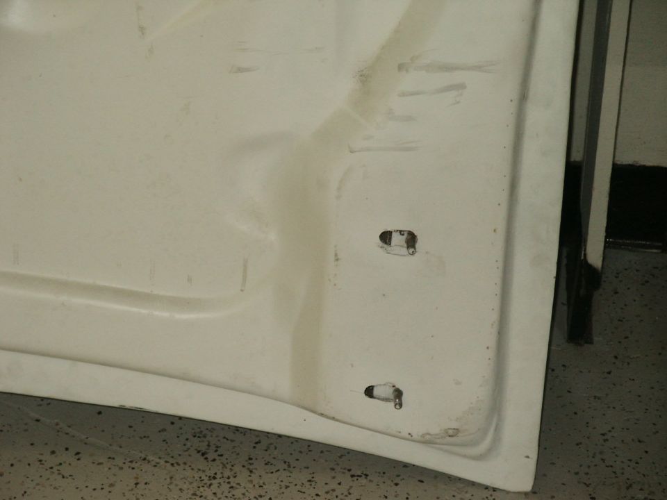 Underside of white hood showing mounting points and Supermotors.net logo