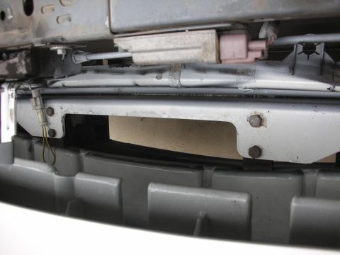 2004 Ford Crown Victoria - Front bumper bracketry and grille detail, showing mounting hardware and wiring.