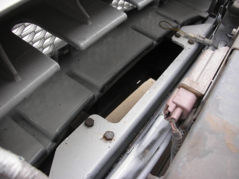2004 Ford Crown Victoria - Detail of car's front end, focusing on grille and bumper components, including wiring.