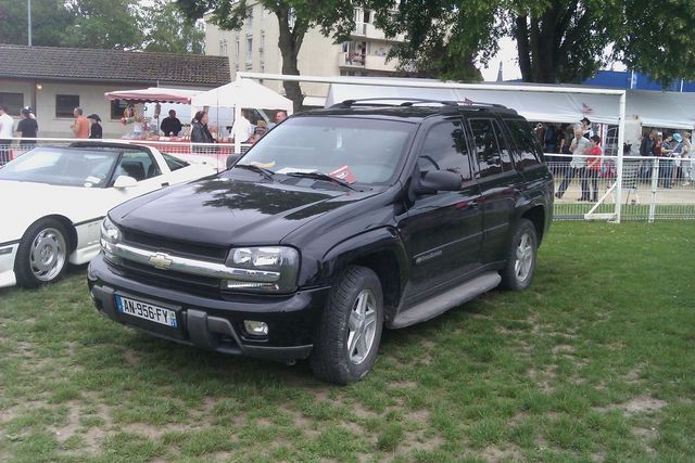 Black Chevrolet Trailblazer SUV parked on grass, front 3/4 view