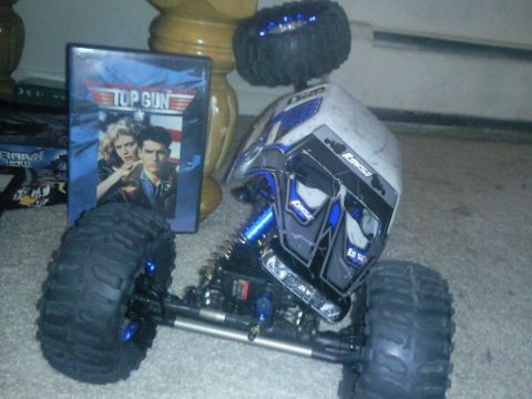 1996 Ford Bronco - A remote-controlled rock crawler sits on carpet next to a Top Gun DVD case.