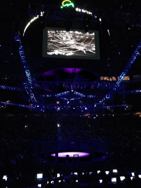 1996 Ford Bronco - An indoor arena is lit with purple and blue lights, with a large screen displaying a map overhead.