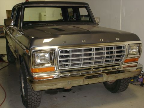 1979 Ford F-250 - This 1979 Ford F-250 pickup truck is shown from a 3/4 front angle, highlighting its grille and headlights.
