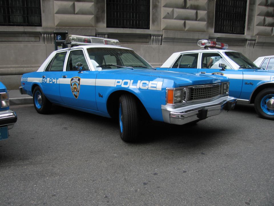 Vintage light-blue and white NYPD POLICE sedan parked in a row