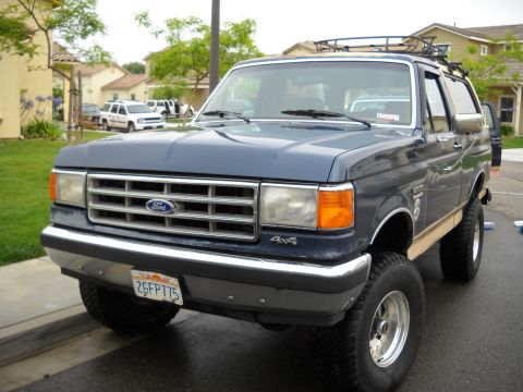 1986 Ford Bronco - This 1986 Ford Bronco is a 4x4 model with a roof rack, seen from the front-right angle.