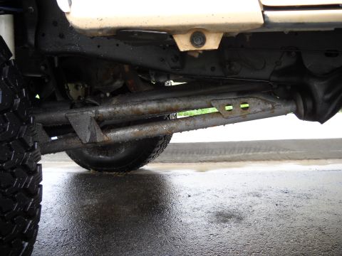 1986 Ford Bronco - Undercarriage view of a vehicle, focusing on suspension and tires.