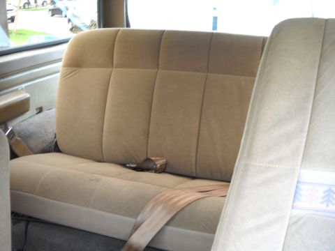 1986 Ford Bronco - Interior view of the rear bench seat and seatbelts in a 1986 Ford Bronco.