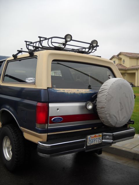 1986 Ford Bronco - This Ford Bronco has a two-tone paint job and a roof rack with auxiliary lights.