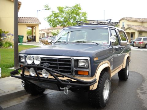1986 Ford Bronco - This 1980s Ford Bronco features a prominent brush guard and auxiliary lights.
