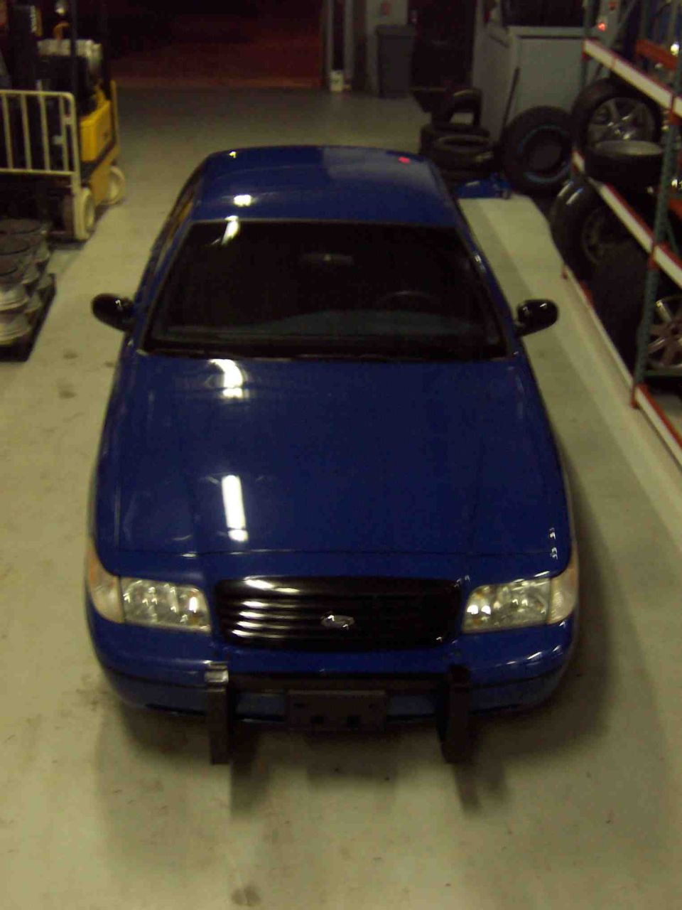 Blue sedan with black grille and push bar, viewed from above