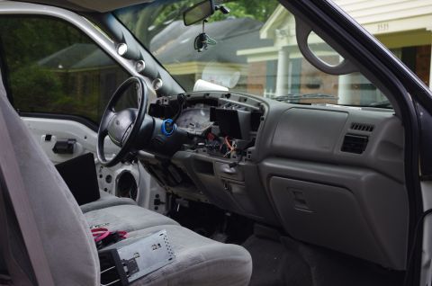 1999 Ford F-250 - The interior of a 1999 Ford F-250 shows a disassembled dashboard with wiring exposed.