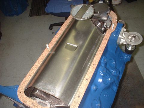 1968 Ford Mustang - Close-up view of an engine's oil pan gasket and oil pump assembly, with the engine block painted blue.