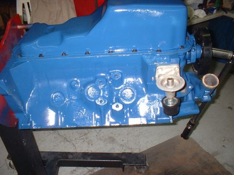 1968 Ford Mustang - A blue painted engine block is shown on a stand, with an oil filter housing attached.