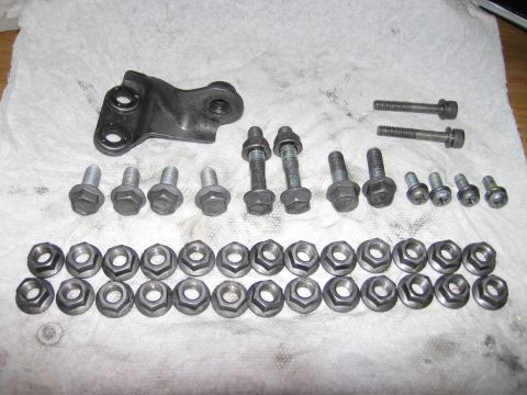 1992 Ford Taurus - Collection of fasteners and a bracket, likely for automotive repair or maintenance.