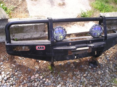 1990 Toyota Pickup/SR5 - Close-up of a black ARB bumper two PIAA fog lights and an ARB badge.