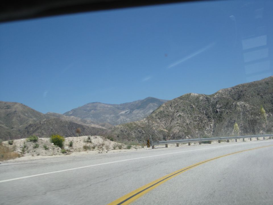 Roadside view of mountains under a clear blue sky