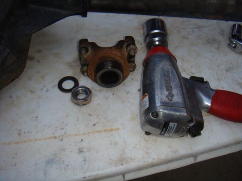 1992 Ford Bronco - Impact wrench and driveshaft components laid out on a workbench for repair.