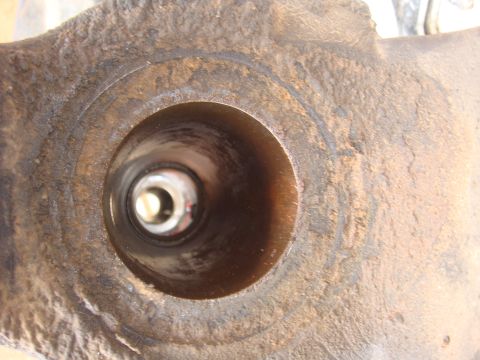 1992 Ford Bronco - A close-up view of a corroded metal axle component, revealing its internal structure.