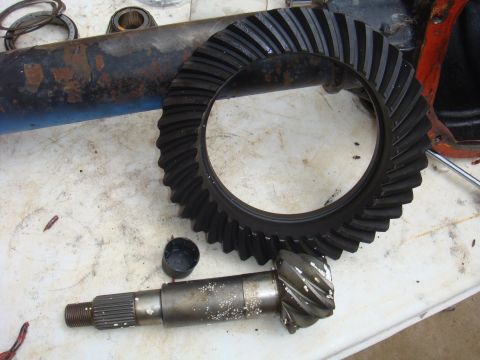 1992 Ford Bronco - Differential gears and part of an axle housing are laid out on a surface.