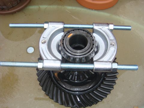 1992 Ford Bronco - A differential gear is shown with a bearing puller tool in place, ready for removal.