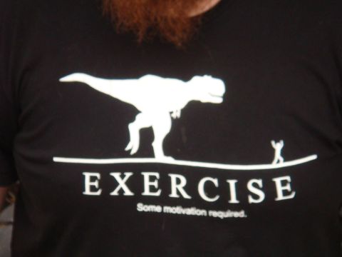 1992 Ford Bronco - T-shirt graphic shows a T-Rex and a stick figure with the text EXERCISE Some motivation required.