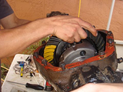 1992 Ford Bronco - Working on differential gears. Tools and shims are laid out on a table nearby.